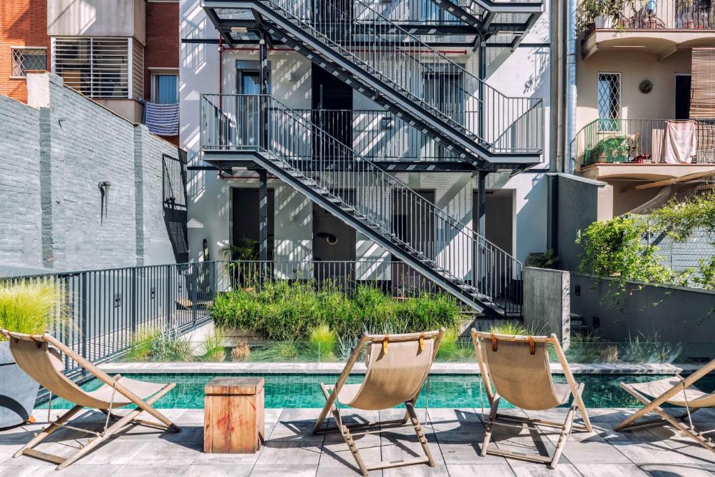 Planted inner courtyard with a small pool and seating below balconied rooms