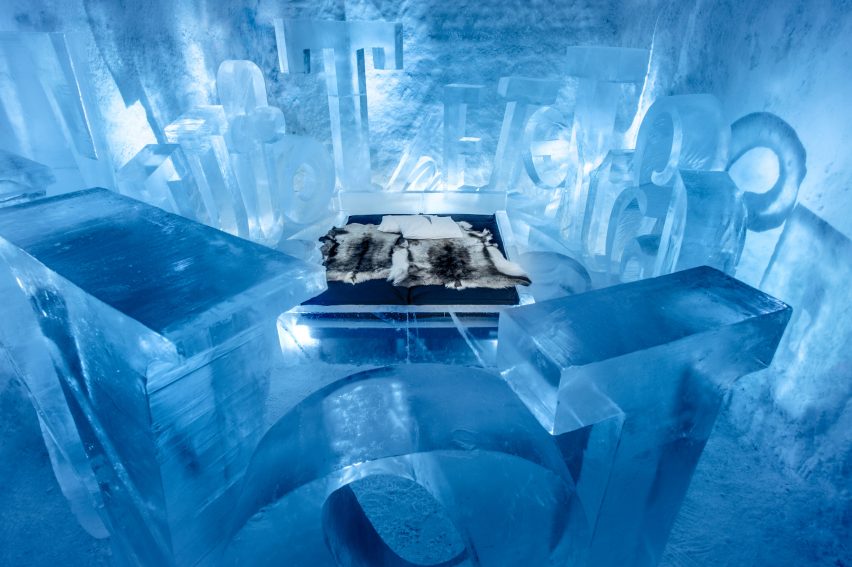 Carved chamber of river ice with a low sleeping platform under a vaulted roof