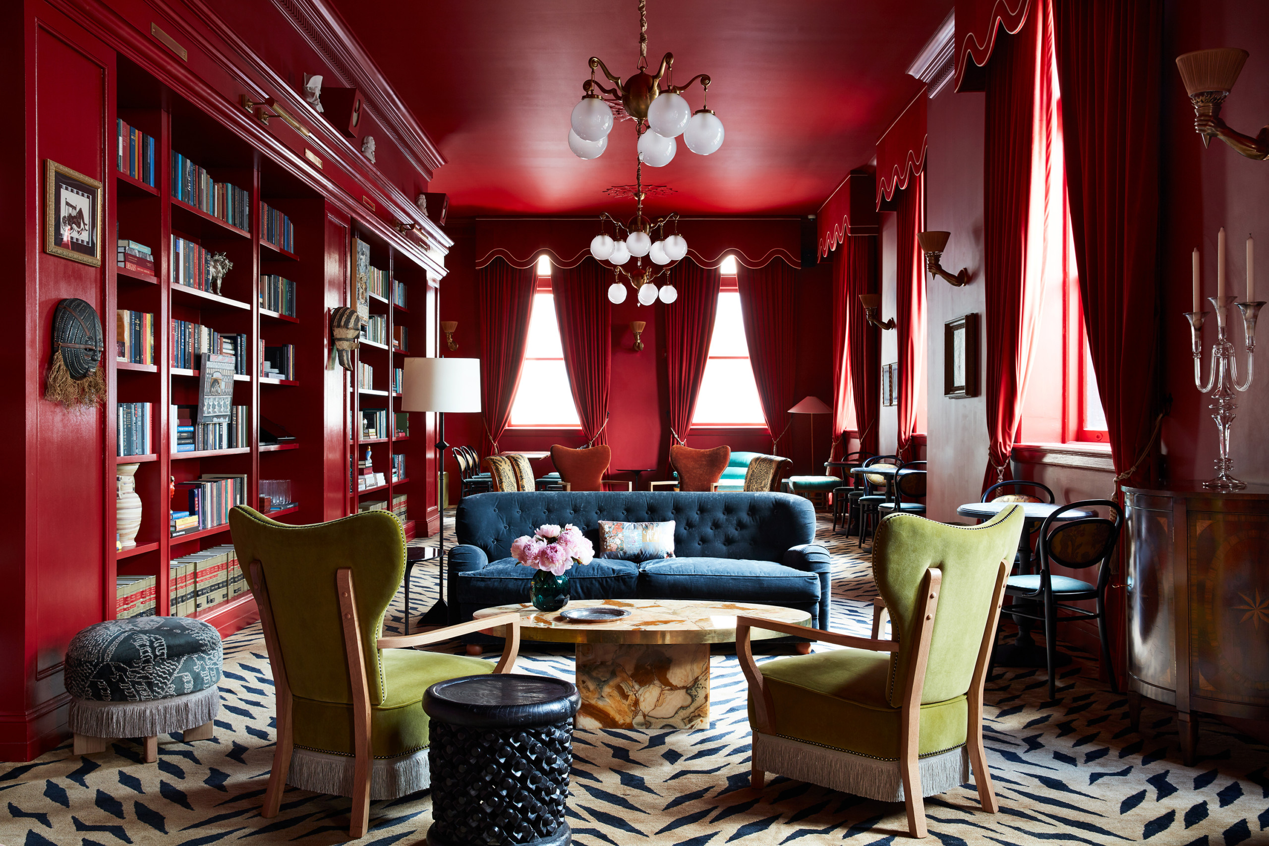 Ground floor salon with high ceilings, patterned floor and grouped seating